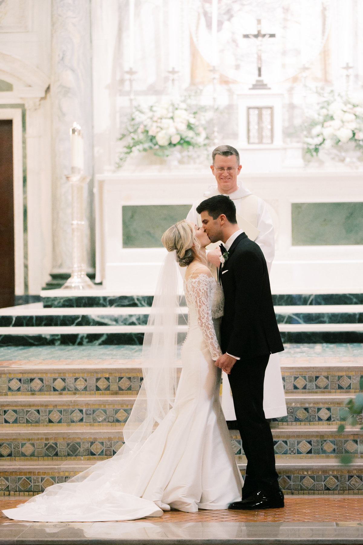 bride and groom kissing during wedding ceremony