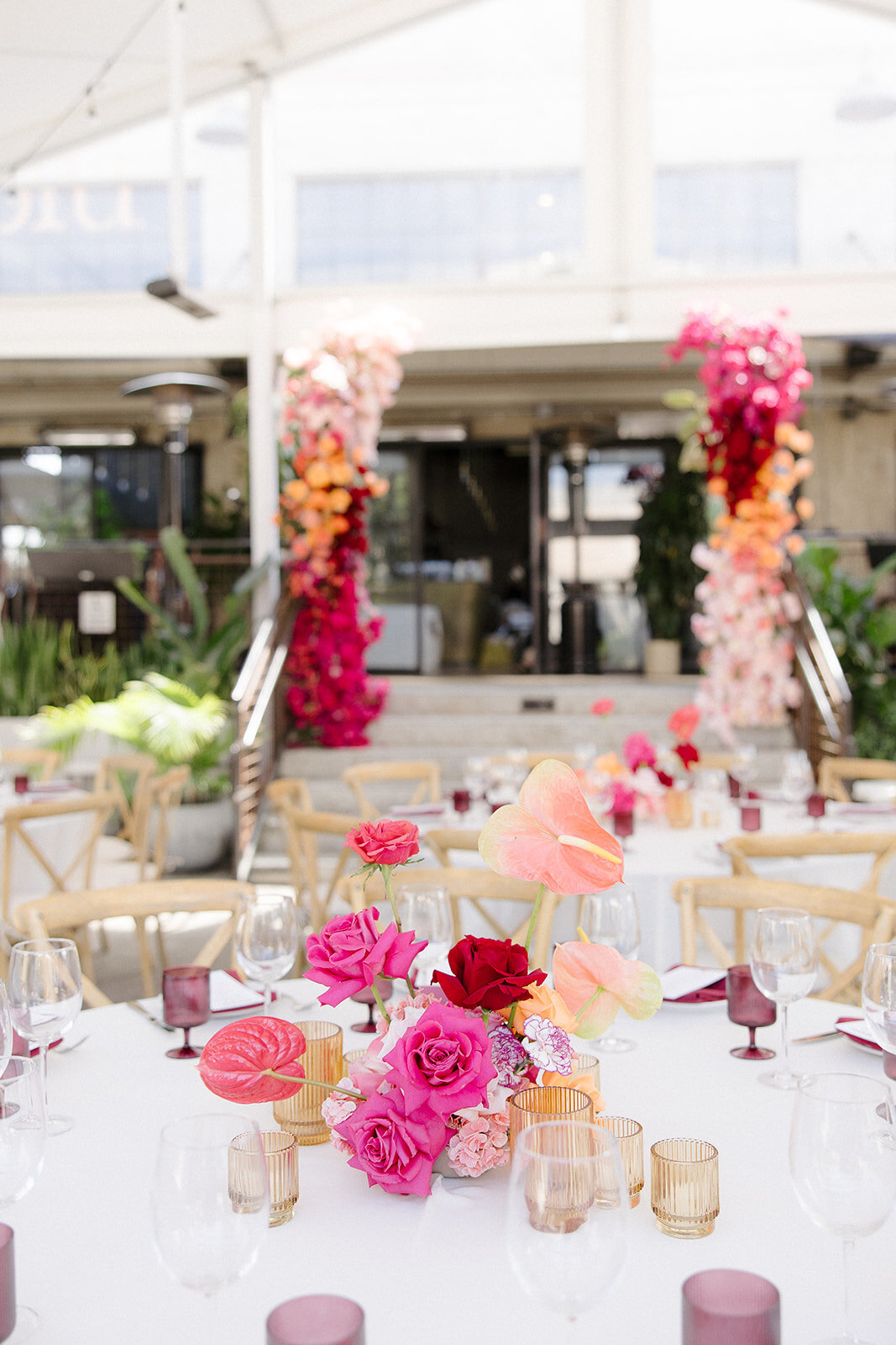 Wedding reception with bright pink and red florals at Rossoblu Restaurant