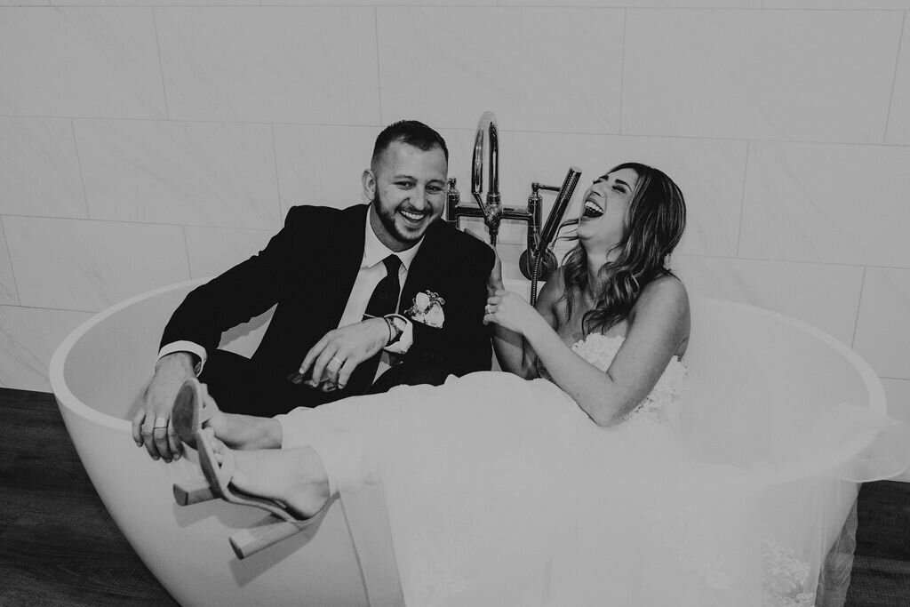 couple having fun sitting in a large bathtub