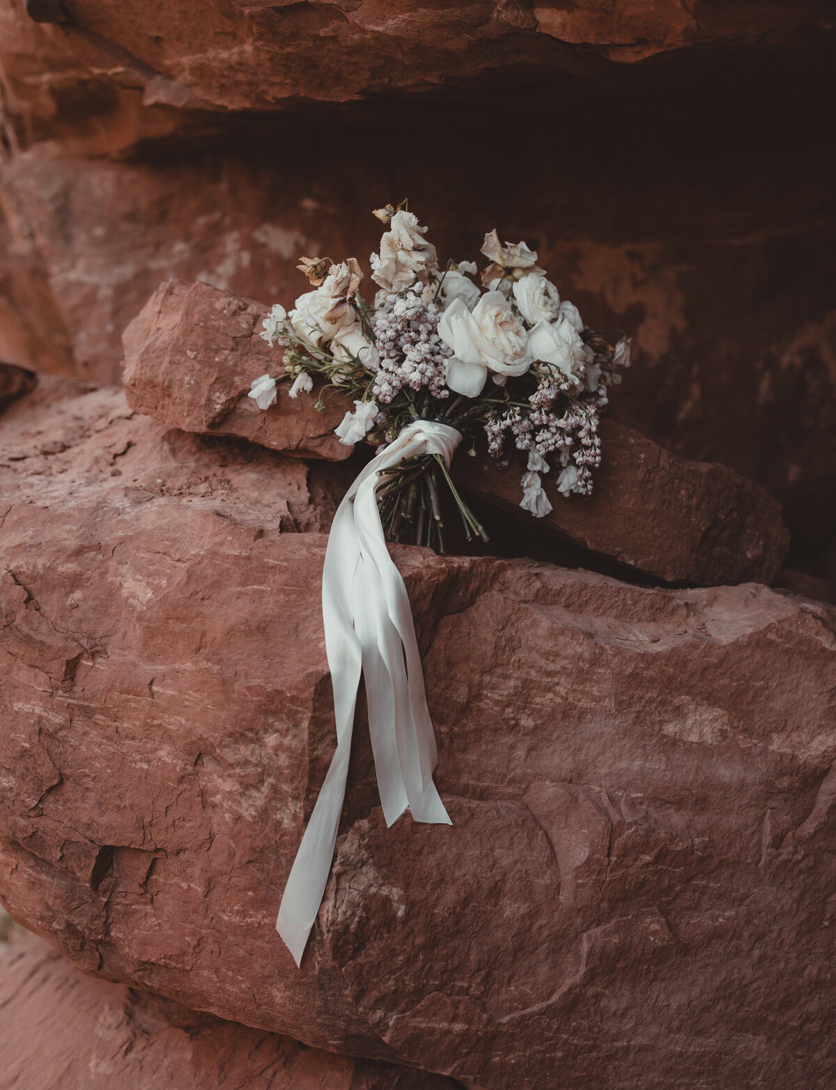 Bride’s lace dress flowing in Sedona wind at Cathedral Rock taken by Kollar Photography