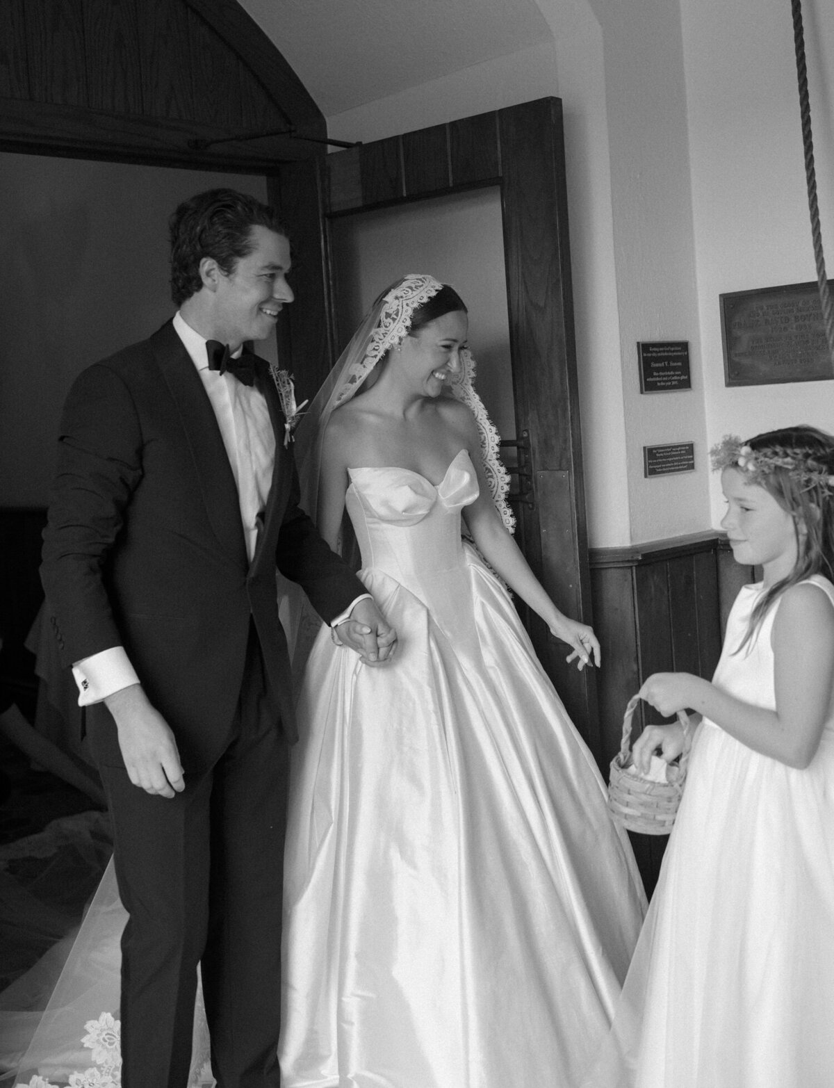 a bride and groom ring the church bell with their flower girls at Christ Church, Detroit