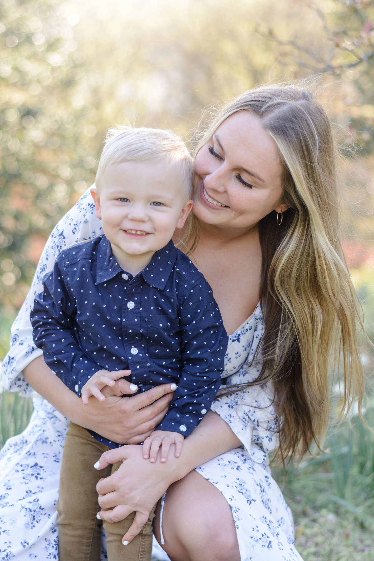 Mom holding her smiling toddler