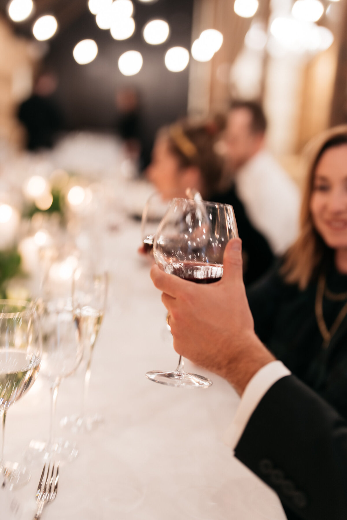 couple toasting wine glasses at wedding reception