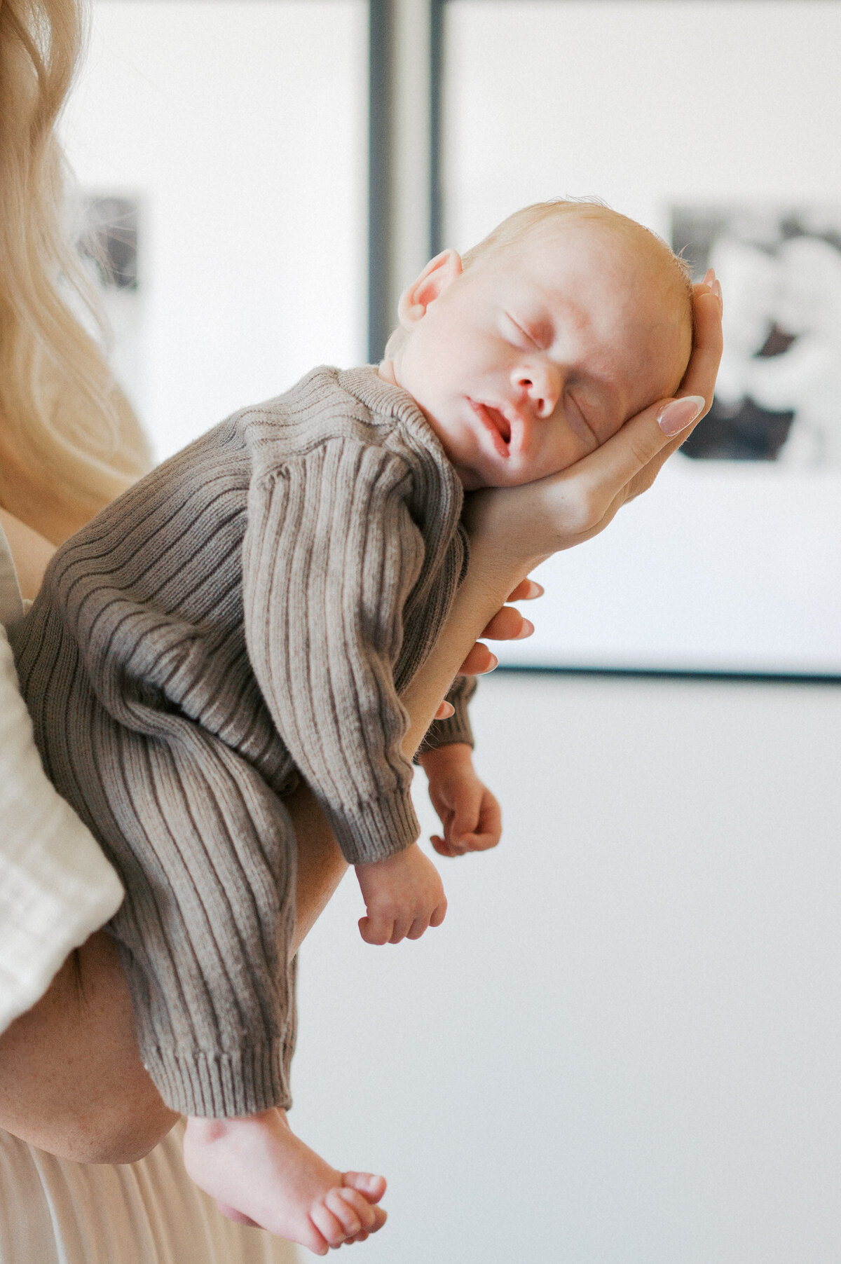 baby sleeps in moms outstretched arms, benbrook newborn photography