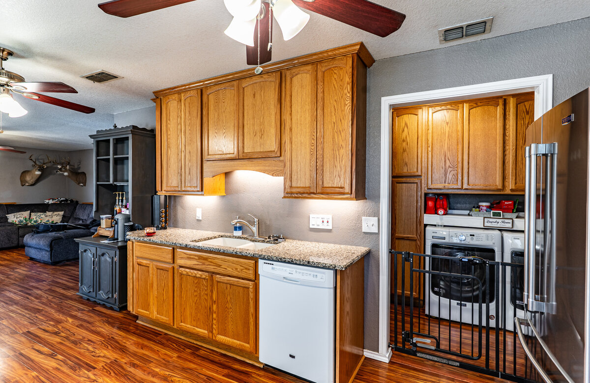 kitchen with granite countertops and under cabinet lighting