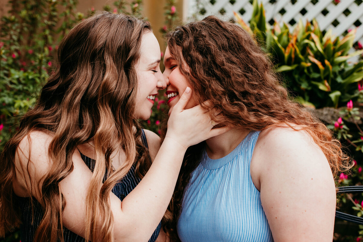 lesbian couple kisses during birmingham engagement session