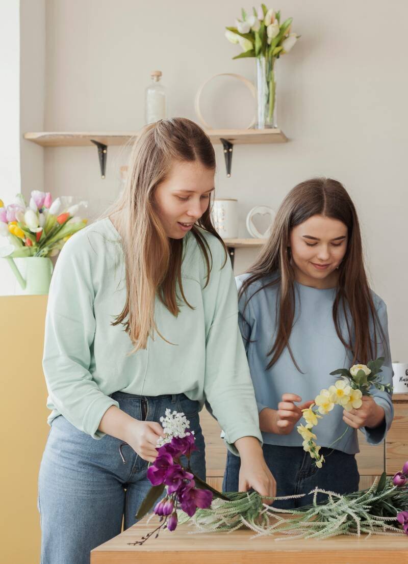 young-beautiful-sisters-holding-flowers