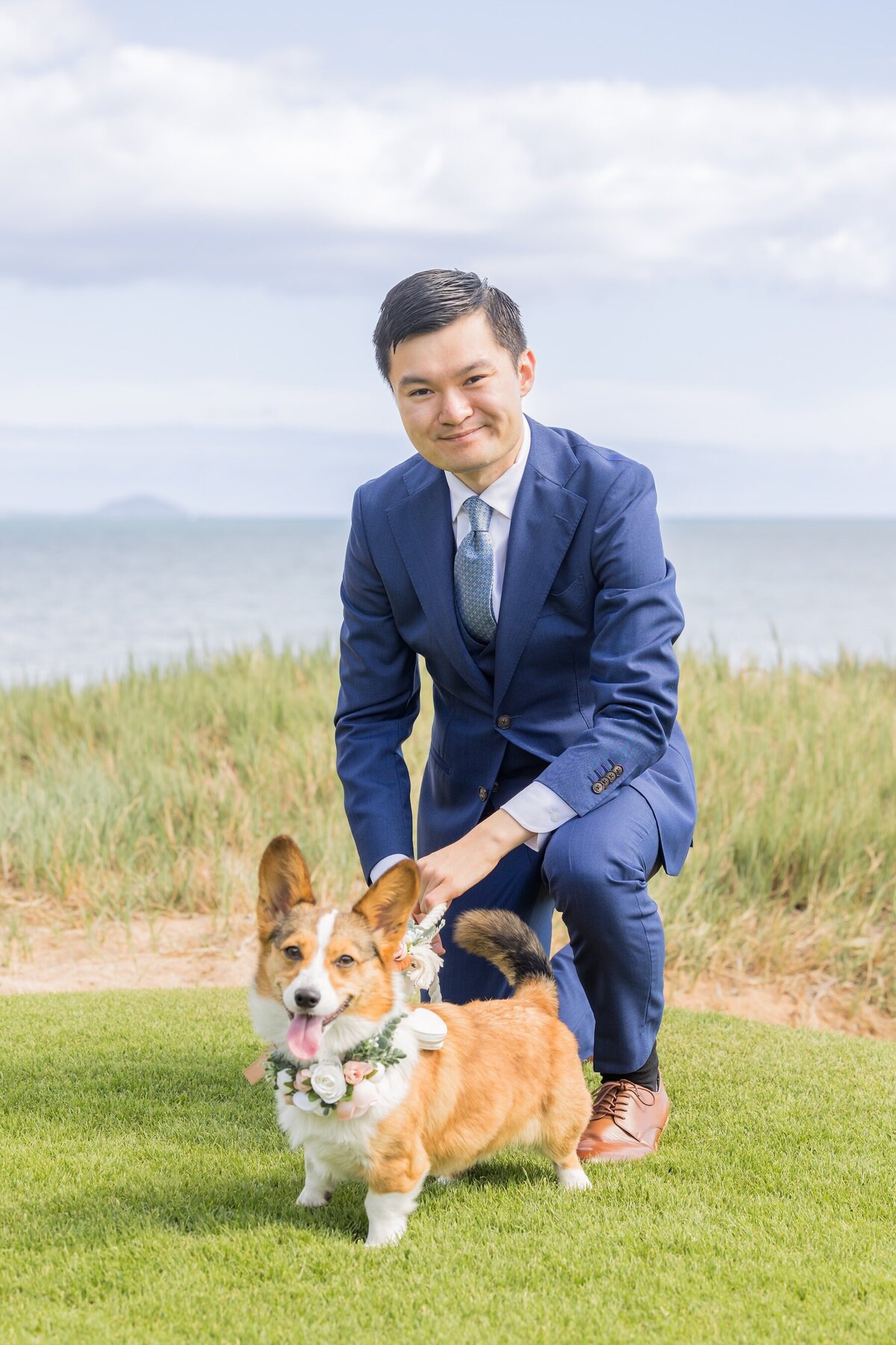Groom with corgi at wedding