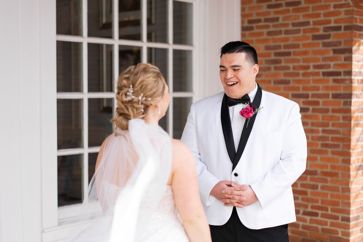 Groom looks shocked and overjoyed to see his bride during their first look at their wedding at Nationwide Hotel and Conference Center in Lewis Center, Ohio.