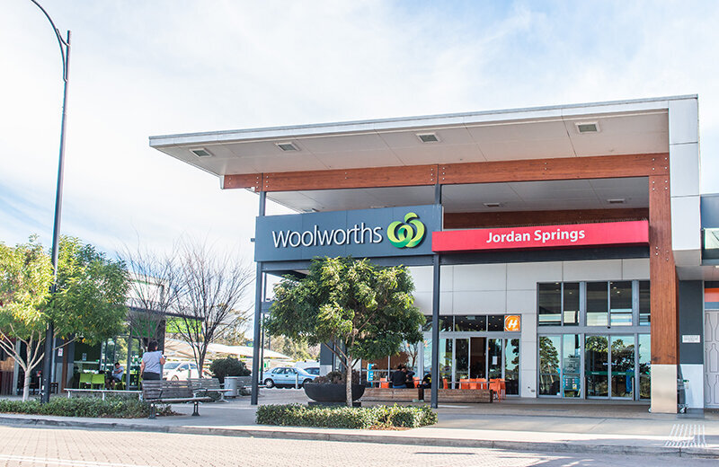 Jordan Springs Woolworths façade with timber awnings and modern architectural finishes, constructed by Serlana Constructions.