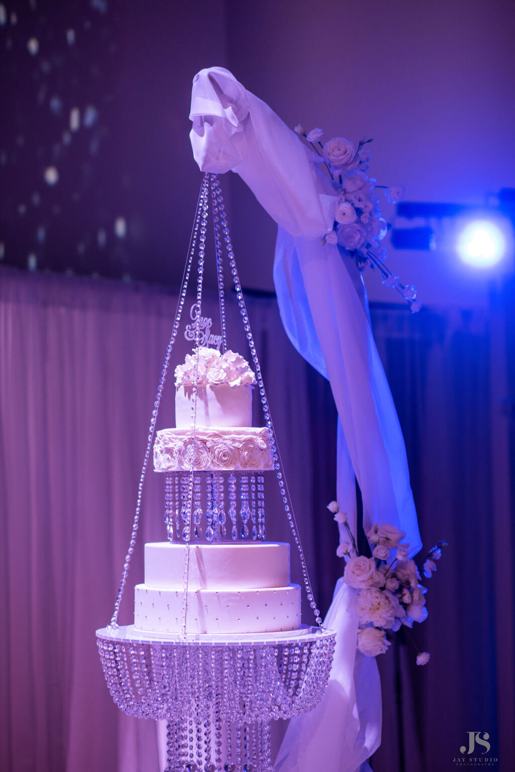 All white diamond and glitter hanging wedding cake.