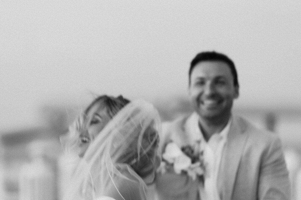 A dreamy black-and-white capture of Monica and Austyn laughing, highlighting the joy of their Islamorada wedding.