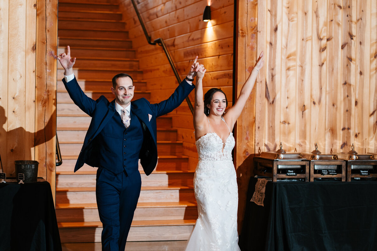 Elegant reception setup with candles, florals, and wooden tables