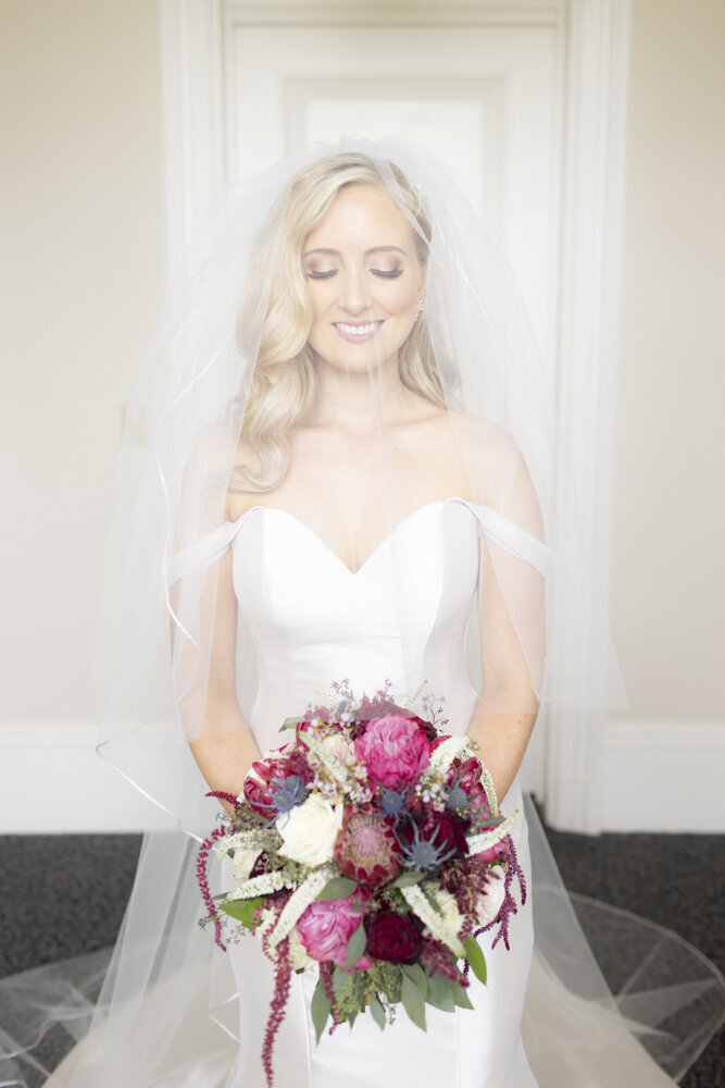 Bride with flowers wedding day Rachel Girouard.