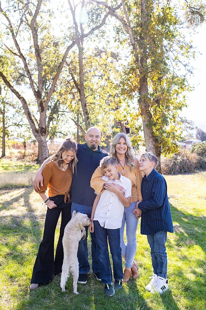 playful family laughing with dog