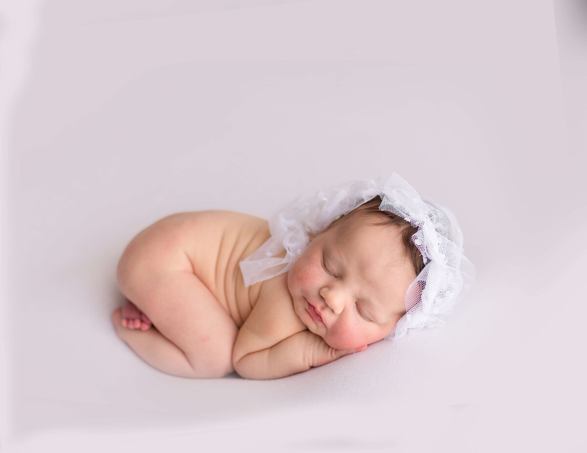 Sleeping newborn on white