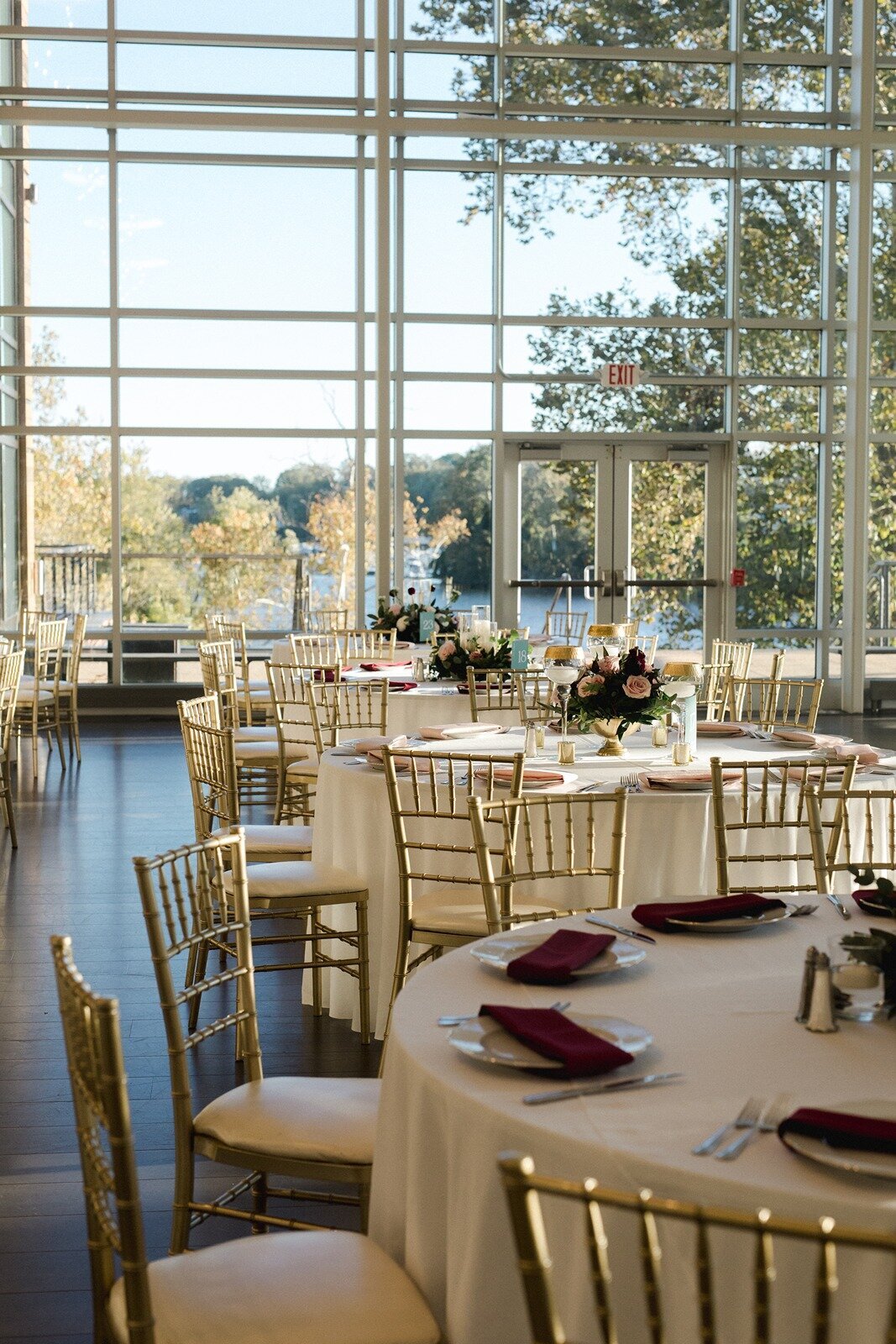 Wedding reception design with white table cloths and golden chairs