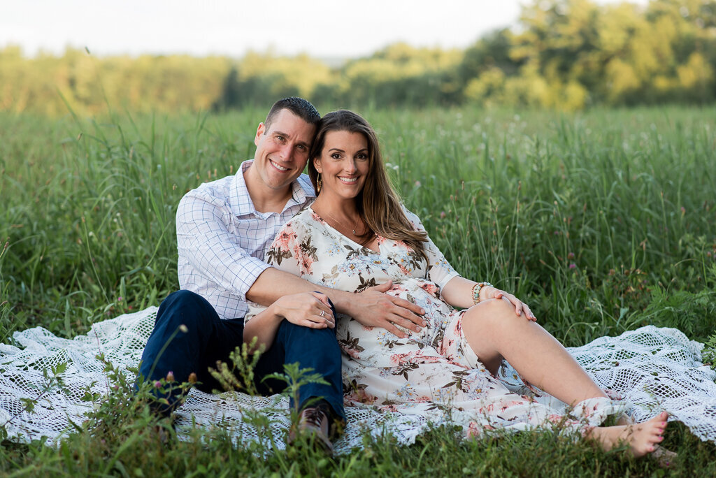 Pregnant couple smiling at the camera at maternity session in field | Sharon Leger Photography | CT Newborn & Family Photographer | Canton, Connecticut