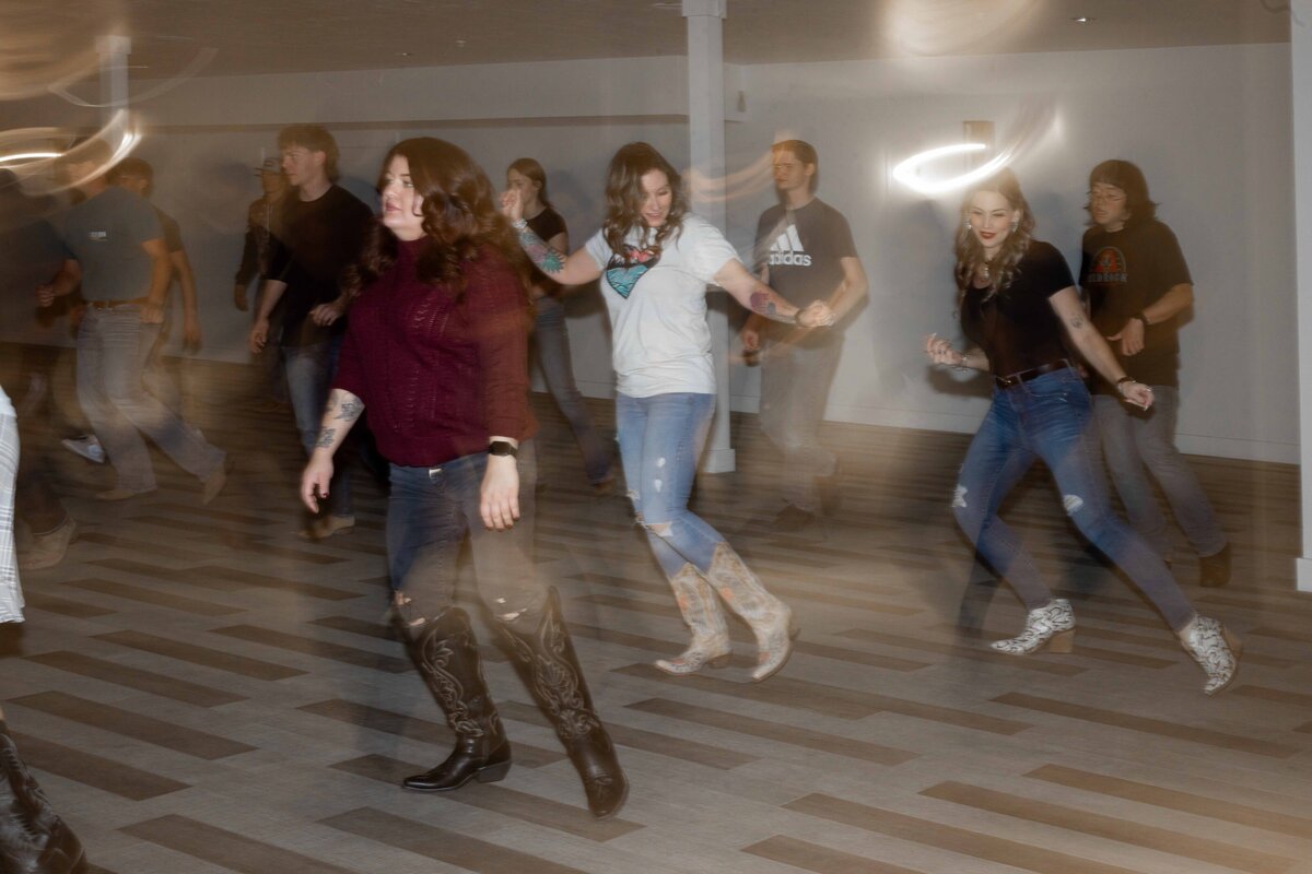 group of women line dancing with a hazy look to it