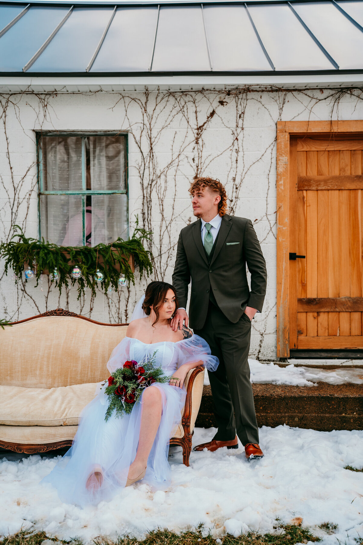  Bride and groom sharing a cozy moment outside snowy cabin