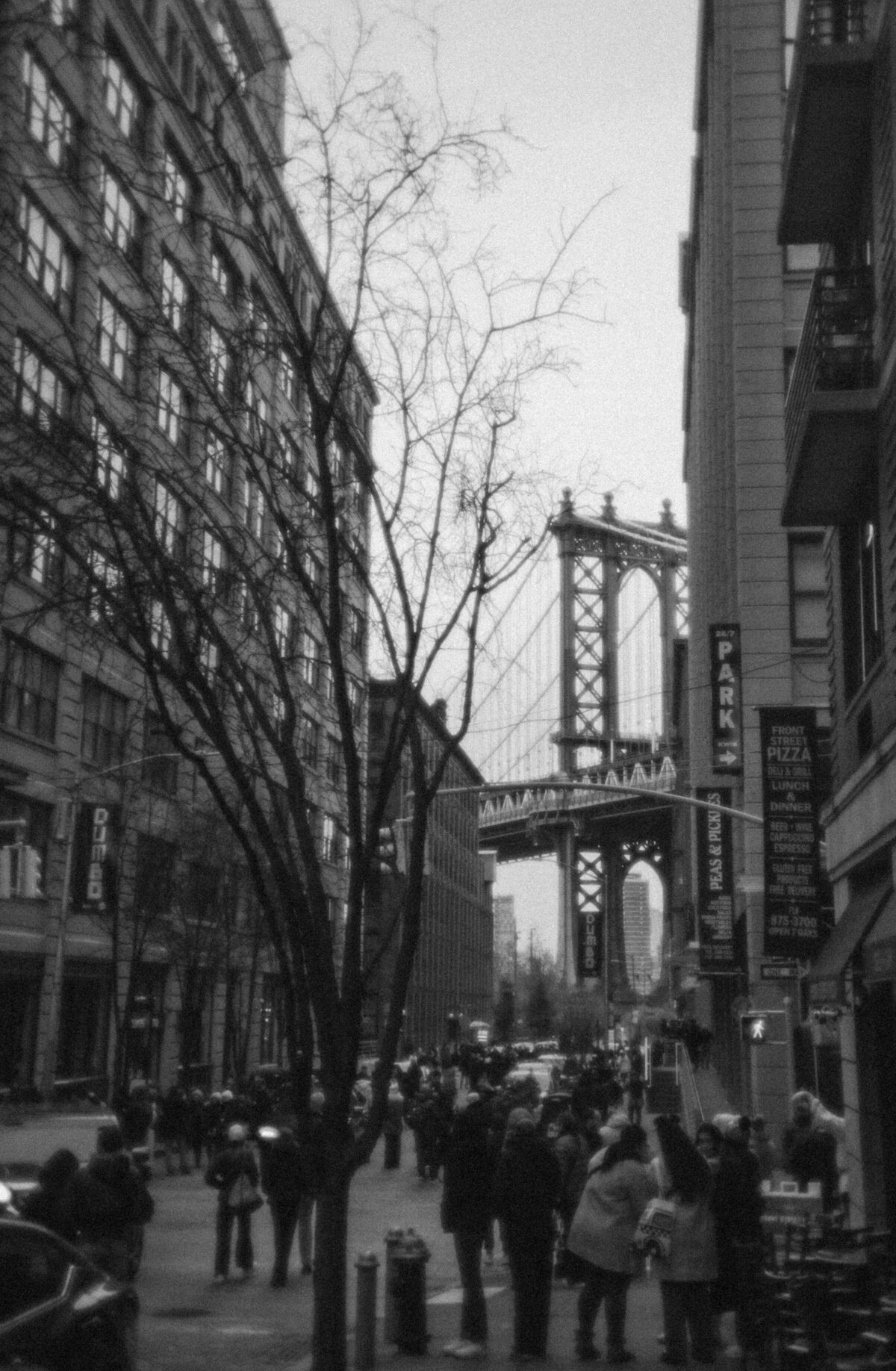 Editorial elopement photography in Dumbo with city skyline views.