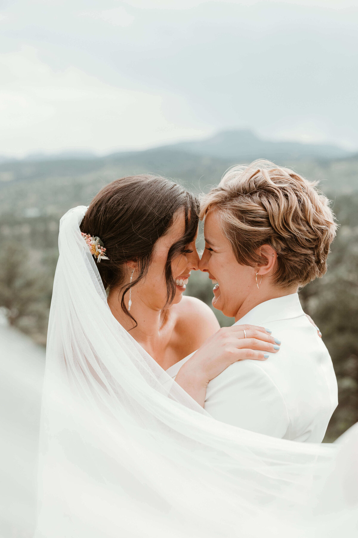 Couple Smiling Nose to Nose With Flowing Veil