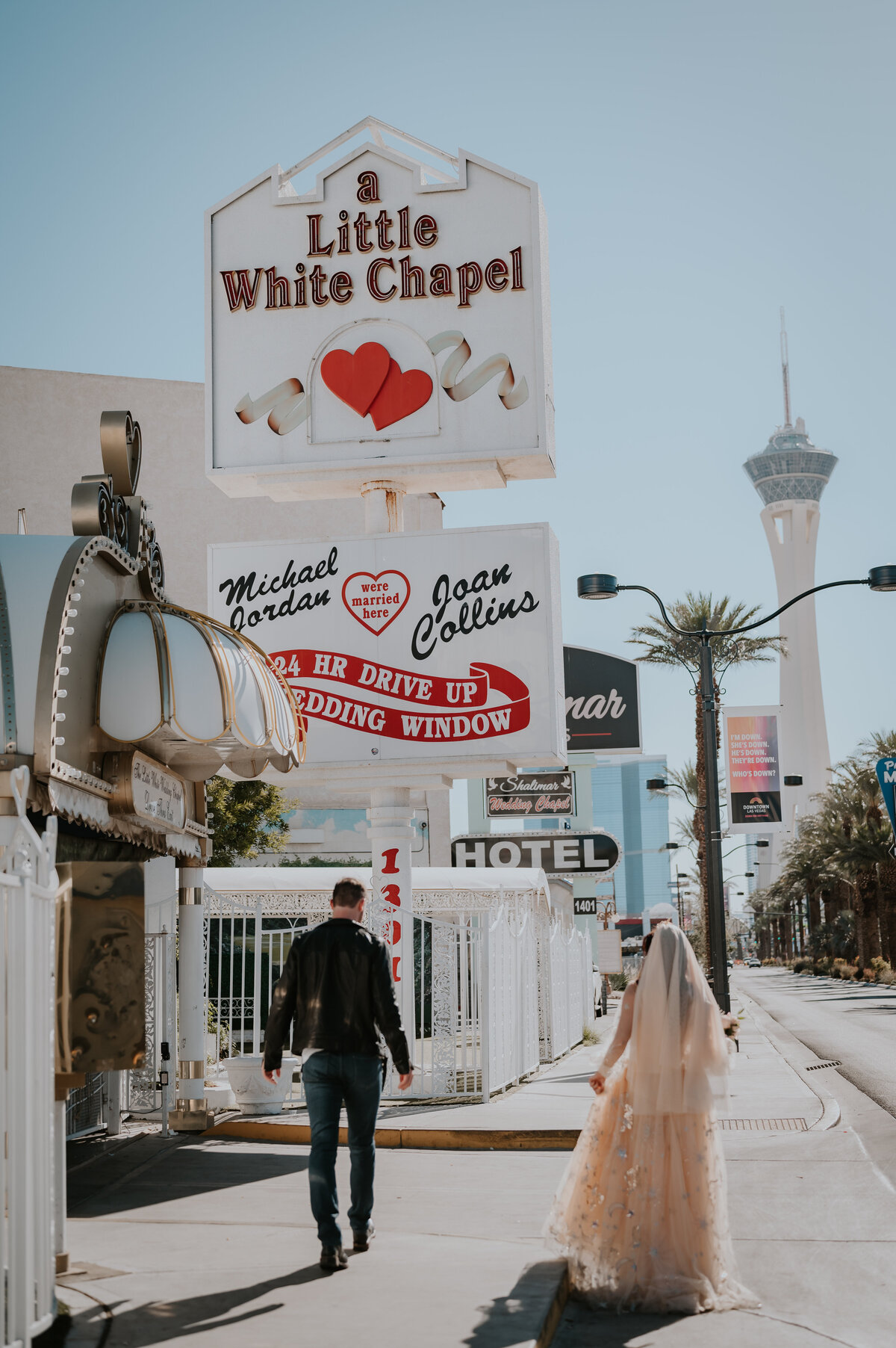 a couple exchanges vows in las vegas with their photographer at the little white chapel