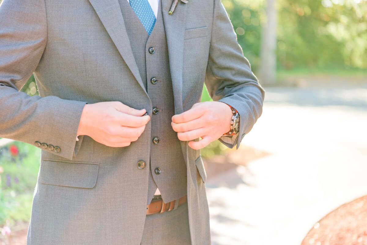 groom-buttoning-jacket