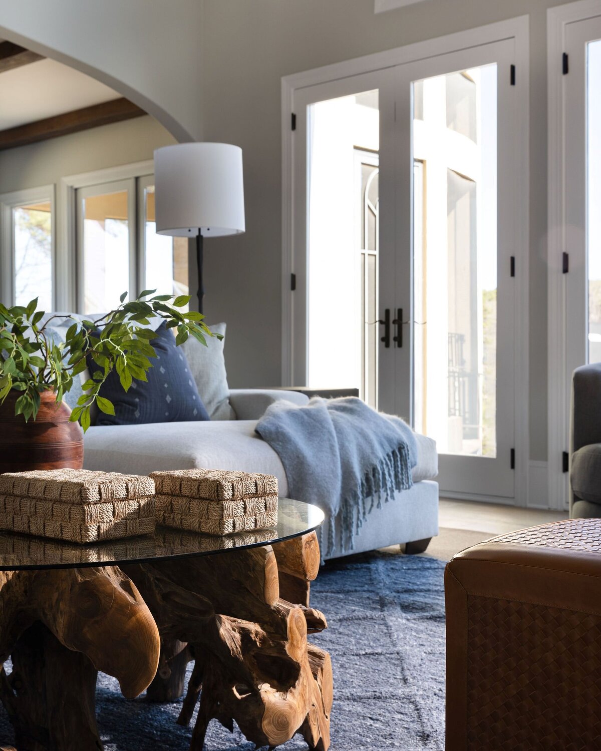 living room with wood table, natural light, and light walls