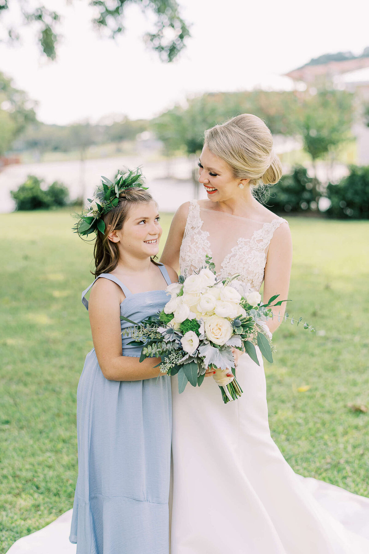 Texas bride smiles at flower girl