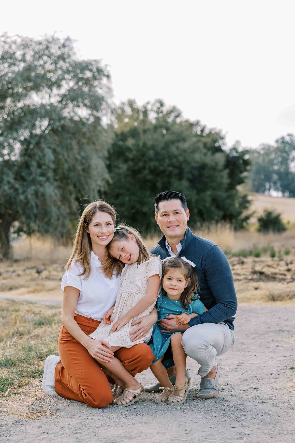 family crouching and smiling