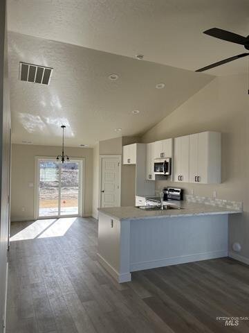 kitchen with wood panel floors and white cabinets