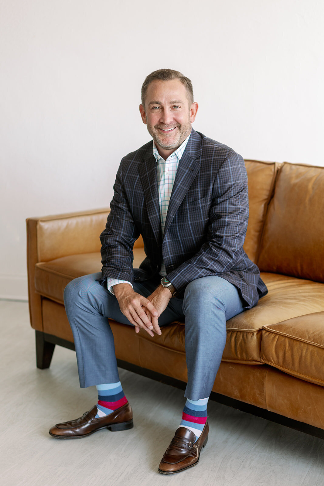 Professional headshot of a Dallas ceo smiling confidently.