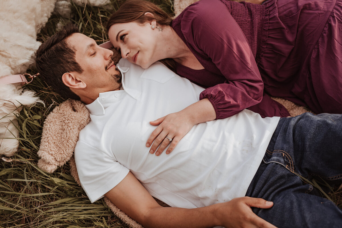 Couples laying in the grass
