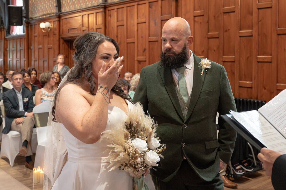 Bride and groom exchanging vows in Worsley Court House ceremony room.