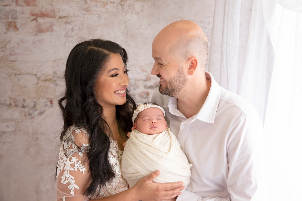 A stunning portrait of a mother cradling her newborn, radiating love and connection. This image is part of our professional newborn photography services tailored for Phoenix families.
