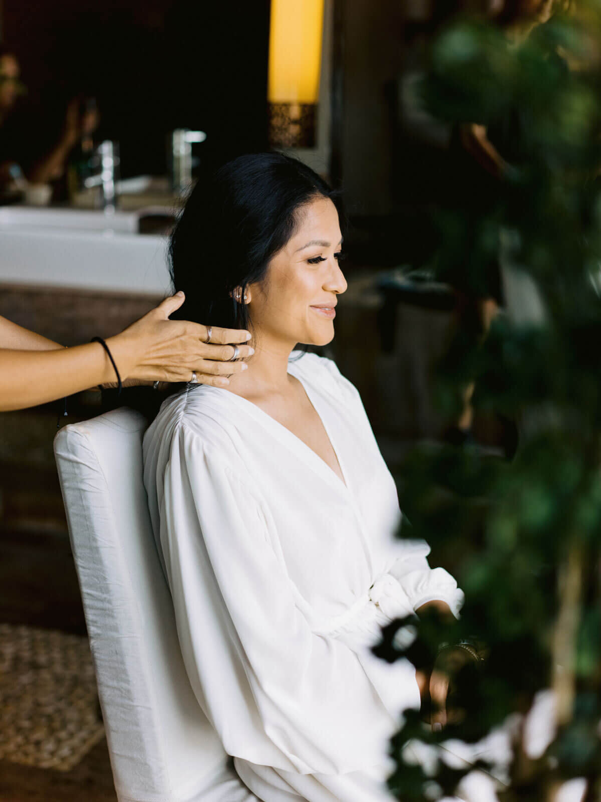 The bride's hair is styled in preparation for the wedding at Khayangan Estate, Uluwatu, Bali, Indonesia. Image by Jenny Fu Studio