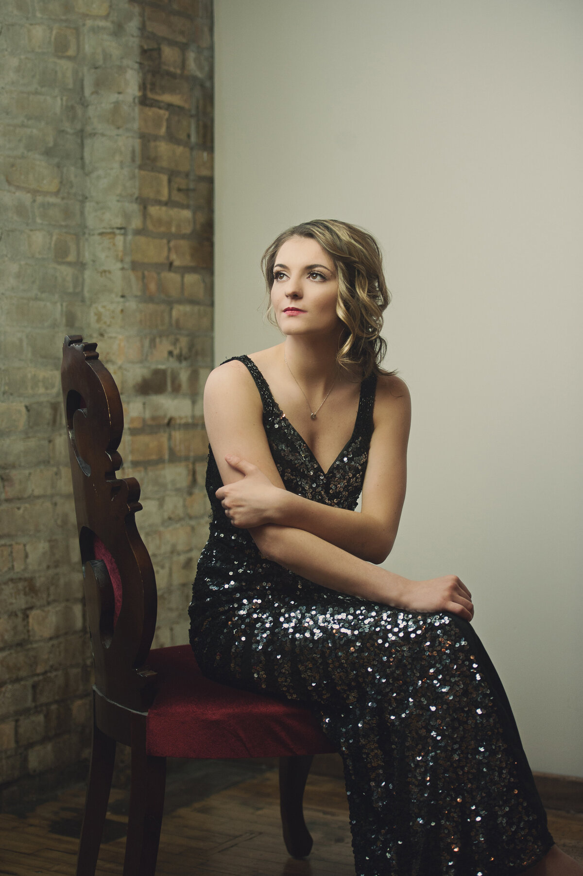 senior girl in black sequin formal gown in studio