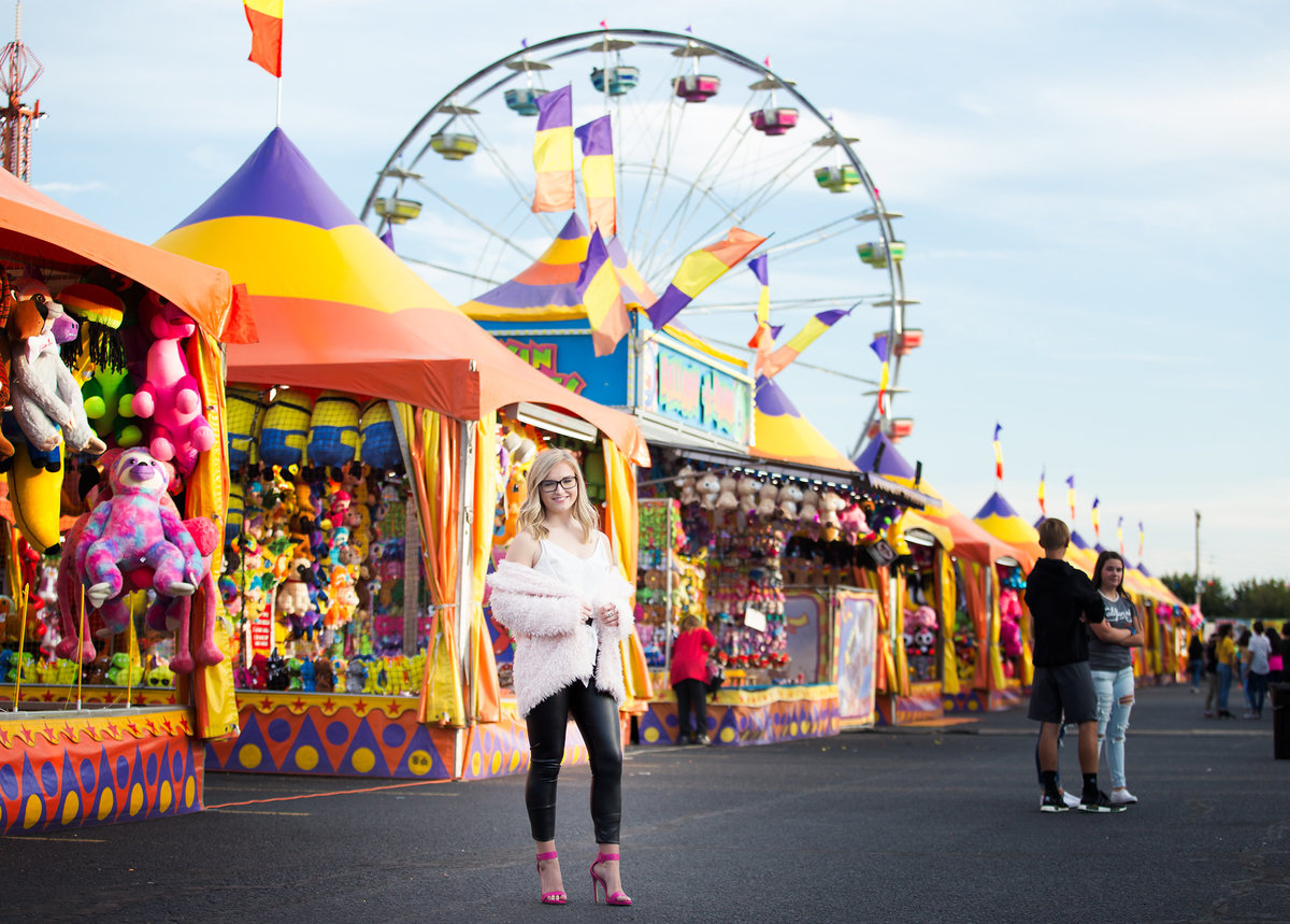 Senior girl standing in middle  of Tri State Fair