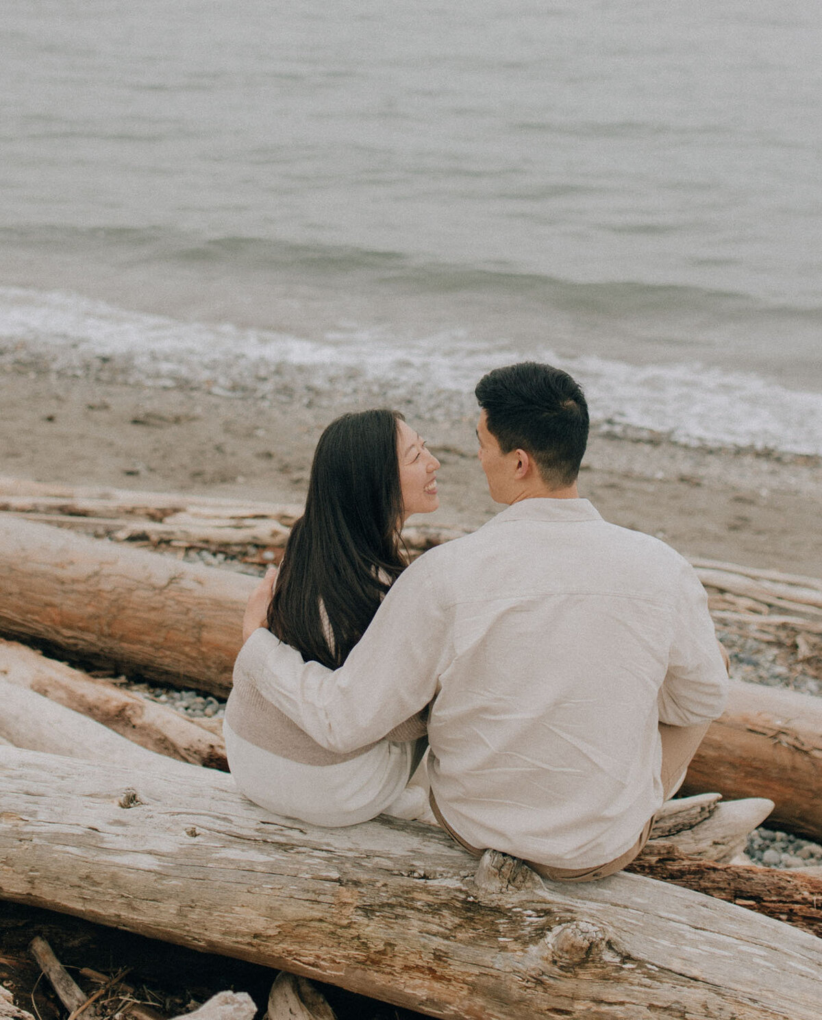 Couple looking at the beach while sitting next to each other