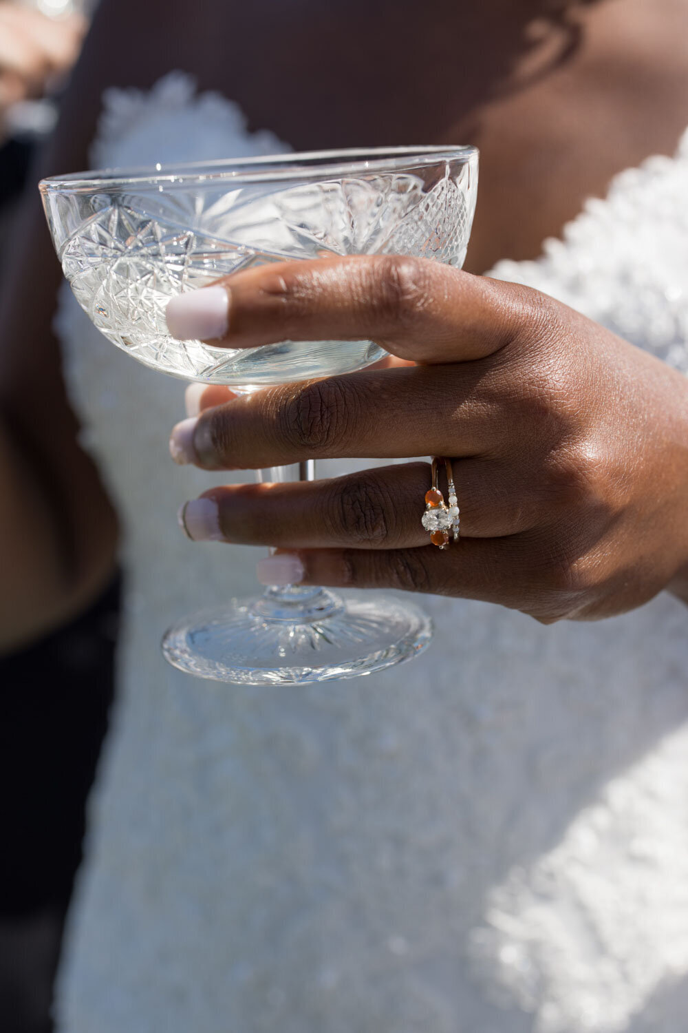 close up photo of bride's hand holding champagne glass