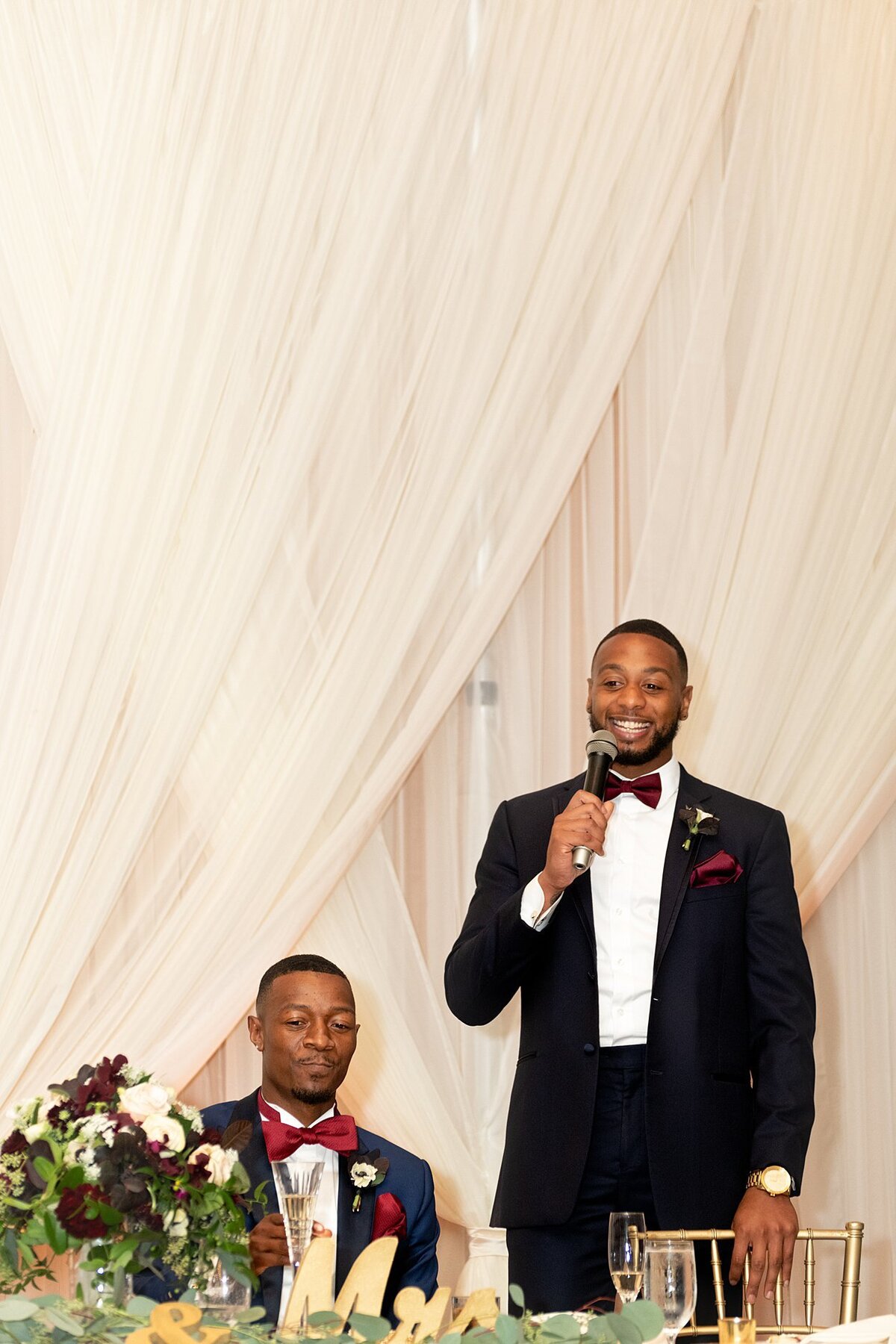 Groom and Best Man during wedding toast