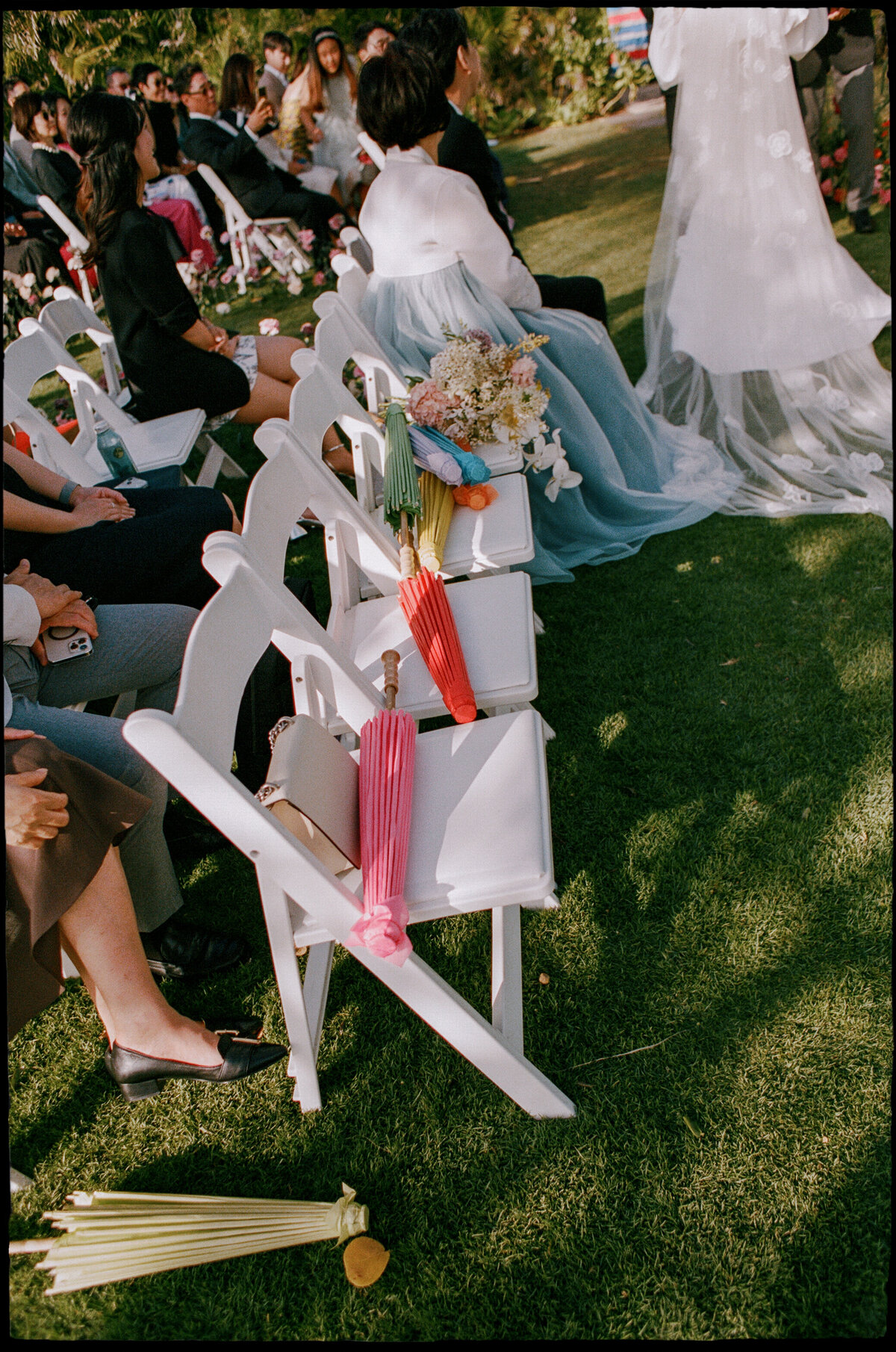 Detail shot of umbrellas at the altar in a tropical wedding setting, captured in a fine art wedding photography style — Carmel wedding photography by Kate Winters Photography.