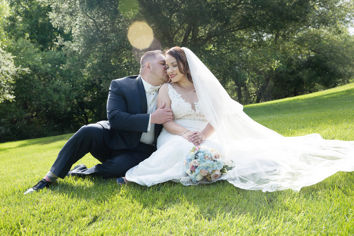 Romantics on grass with bride and groom