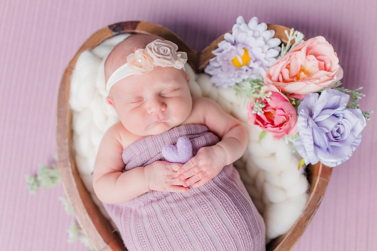 newborn girl in mauve with florals and heart