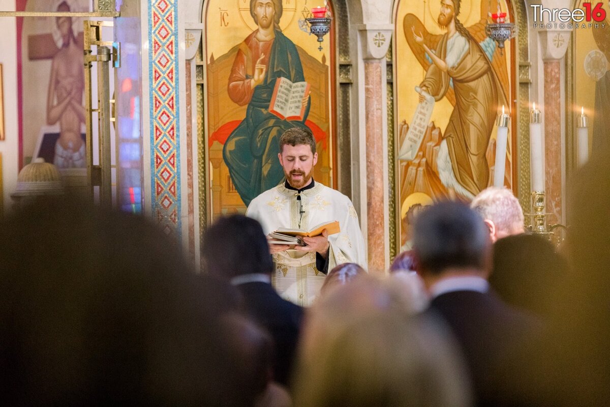 Priest does a reading during a wedding ceremony