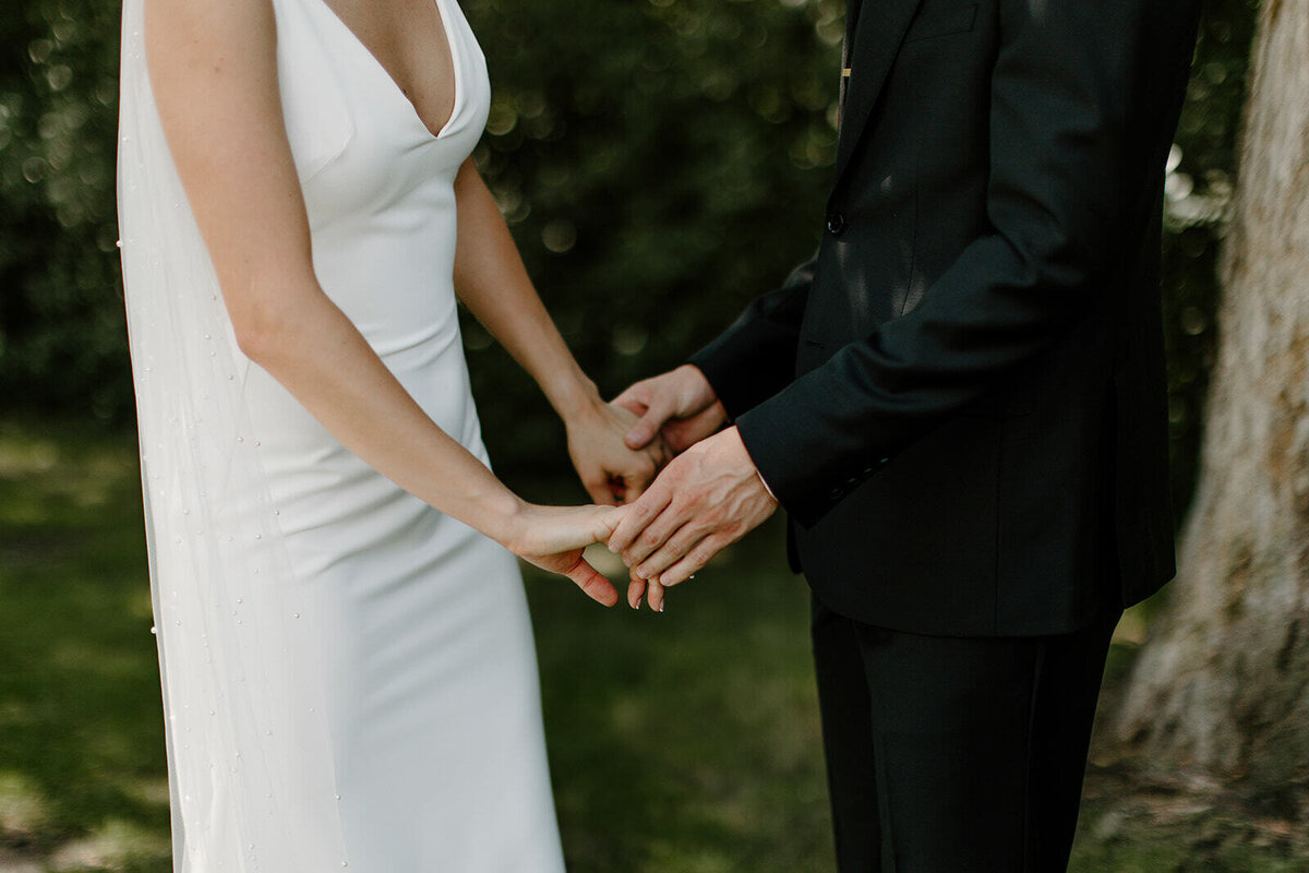 bride and groom holding hands after first look