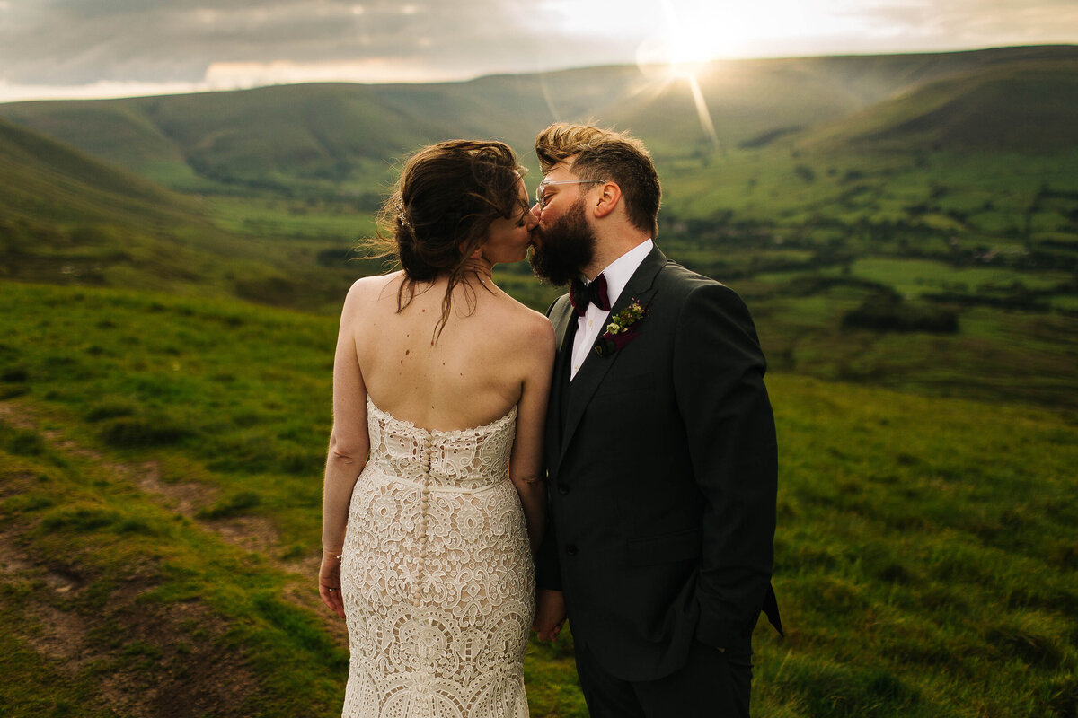 Couple kissing in the countryside at sunset