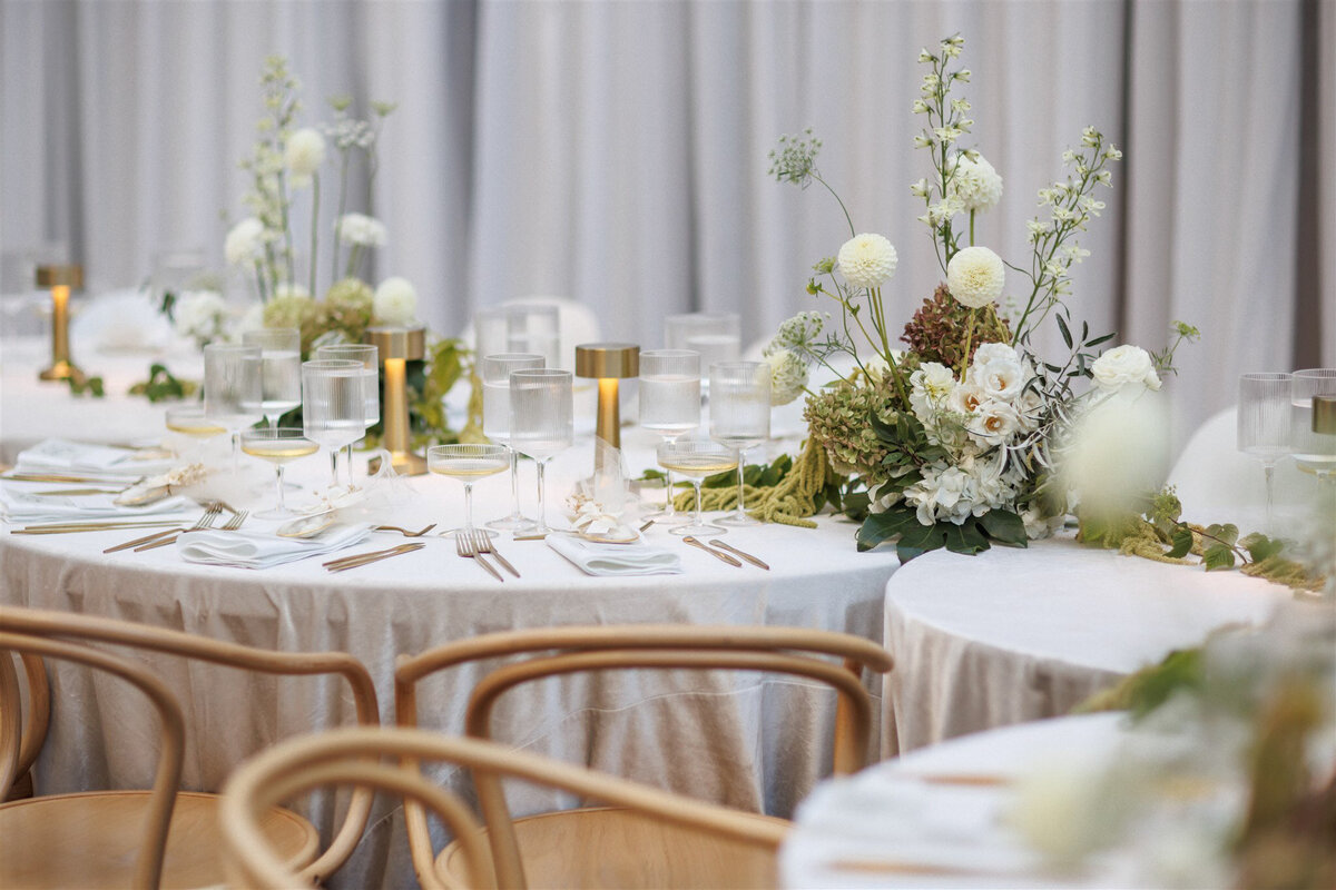 Modern, organic wedding centrepieces featuring draped greenery at the Cathcart.