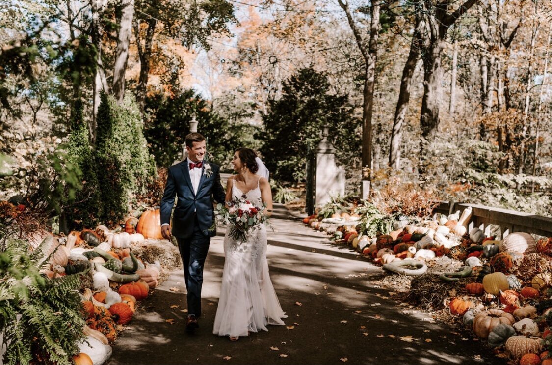 Bride and Groom walking by pumpkins